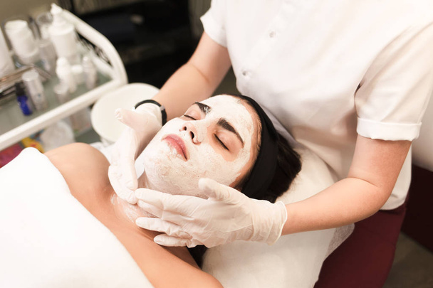 Procedure for applying a moisturizing nourishing mask to the face in a beauty salon - Photo, Image