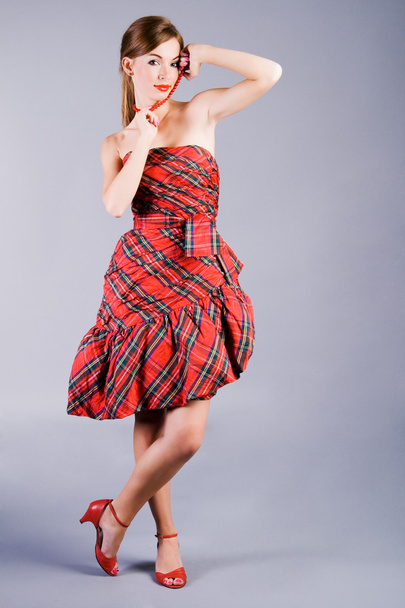 Beautiful alluring girl in red dress - Фото, изображение