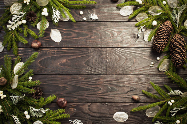 Christmas fir branches and decorations on dark wooden background - Фото, изображение