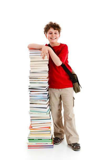 Student standing close to pile of books on white background - 写真・画像