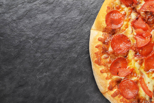 Pepperoni pizza on black slate background with ocopy space - Photo, Image