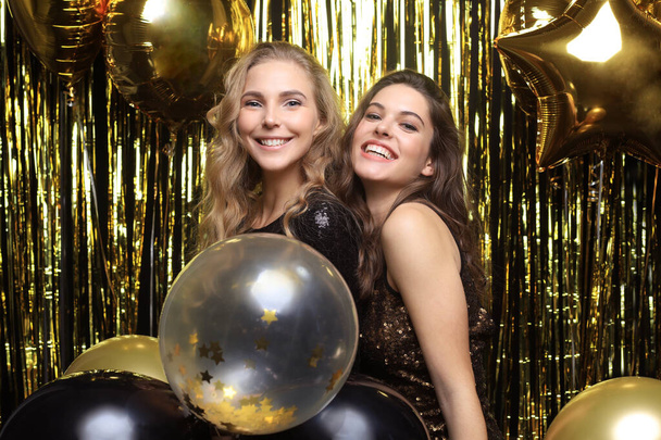 Beautiful girls celebrating New Year. Gorgeous smiling young women enjoying party celebration, having fun together. - Photo, image