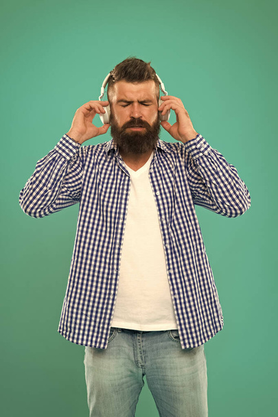 music. brutal caucasian hipster with moustache. Happy man hipster listen to music. Bearded man. Hair and beard care. Man in earphones. Young and brutal. Mature hipster with beard. e book education - Foto, Imagen