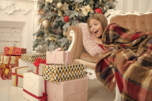 Child enjoy the holiday. Beat the Christmas rush. The morning before Xmas. Little girl. Christmas tree and presents. Happy new year. Winter. xmas online shopping. Family holiday - Photo, image
