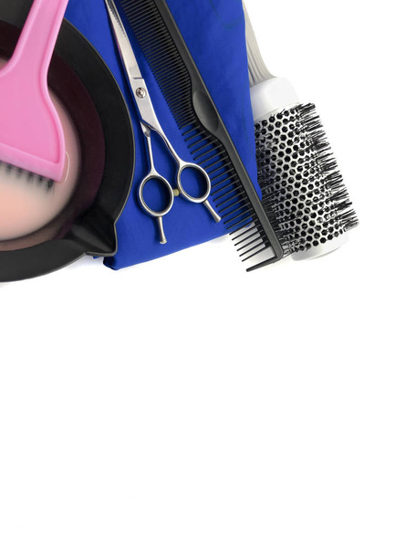 Bowl for paint, comb, pink brush and scissors isolated on a white background. Set of professional hairdressing tools for hair coloring. Composition of tools for a beauty salon. - Photo, Image