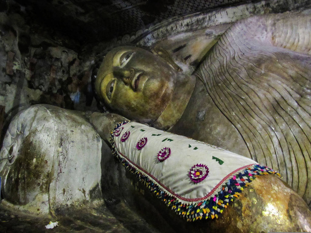 Dambulla golden cave temple inside with buddha statues carved in the rock of cave temple in Sri Lanka - Photo, Image