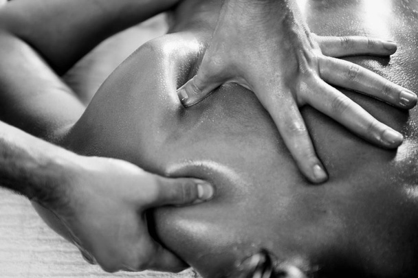 Close up of woman with oiled skin having relaxing back massage - Foto, imagen