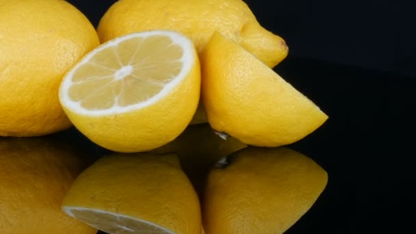 Ripe fresh juicy yellow lemon on black background - Footage, Video