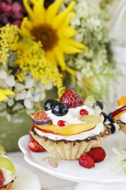 Colorful cupcakes with fresh fruits.  - 写真・画像