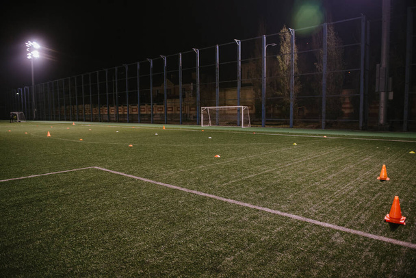 Orange cones for training football on the field - Φωτογραφία, εικόνα