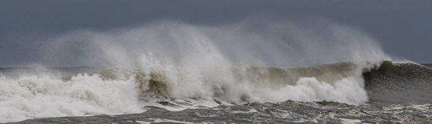 Big wave with water blowing backwards from strong winds - Photo, Image