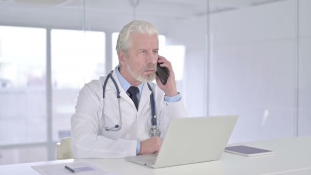 Happy Senior Old Doctor Talking on Smart Phone  - Video