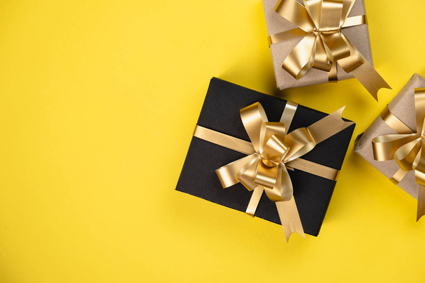 Holiday composition. Various gift boxes on pastel yellow background. Christmas, new year, birthday concept. Minimal style, Flat lay, top view, copy space - Fotó, kép