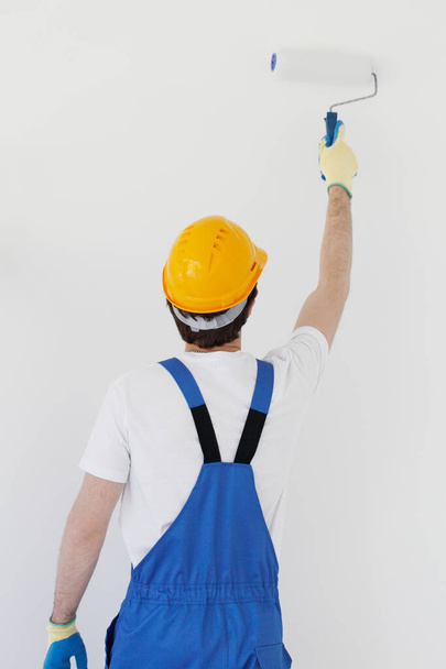 Worker painting walls in new house - Photo, Image