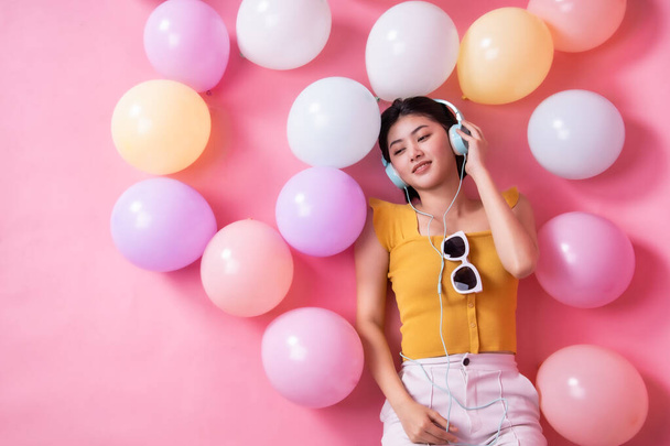 Asian Beauty girl with colorful air balloons laughing over pink  - Φωτογραφία, εικόνα