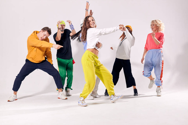Funny men and women dancing hip-hop at studio - Foto, Bild
