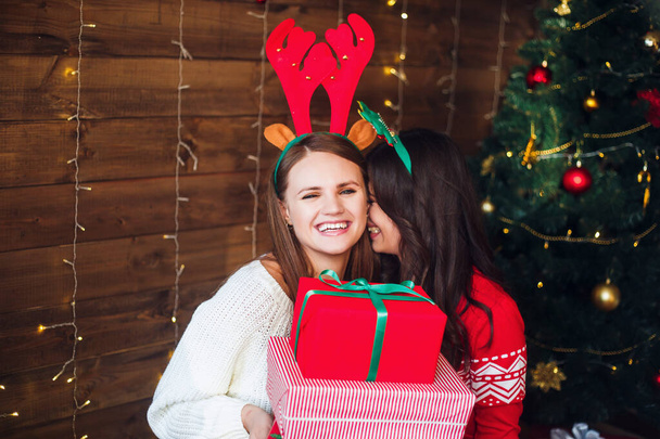 Best friends hugging each other and giving a christmas presents. - Foto, immagini