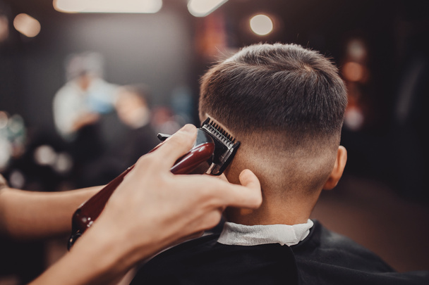 Barbershop Man Barber in men hairdresser does hair with scissors - Photo, image