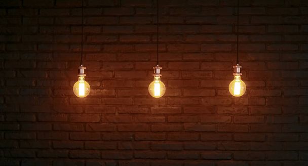 Three Edison lamps against a structured brick wall - Photo, Image