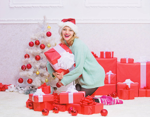 Give her gift that she always wanted. Woman excited blonde hold gift box with bow. Perfect gift for girlfriend or wife. Opening christmas gift. Girl near christmas tree happy celebrate holiday - Foto, imagen