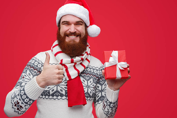 Pleased man approving Christmas present - Фото, зображення
