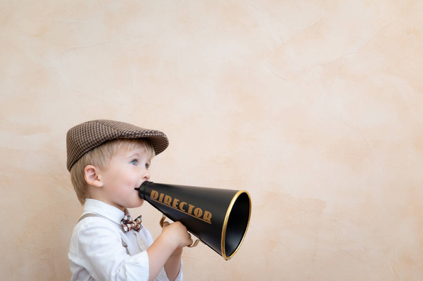 Child shouting through vintage megaphone - Фото, изображение