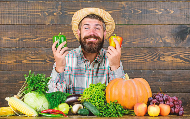 Buy fresh homegrown vegetables. Man with beard proud of his harvest vegetables wooden background. Farmer with organic vegetables. Excellent quality vegetables. Just from garden. Grocery shop concept - Φωτογραφία, εικόνα