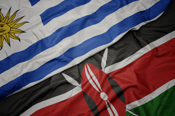 ondeando colorida bandera de Kenya y bandera nacional de uruguay
. - Foto, Imagen