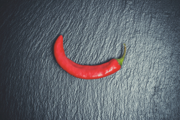 Hot peppers for spicy dishes on a black background - Photo, Image