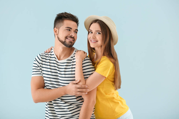 Portrait of happy young couple on color background - Photo, Image