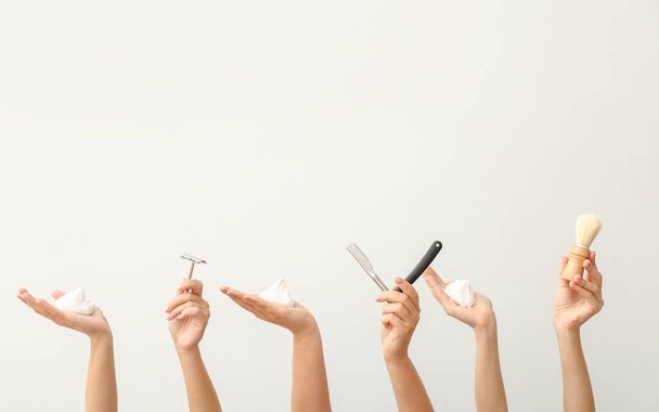 Hands with different tools for shaving on white background - Photo, Image