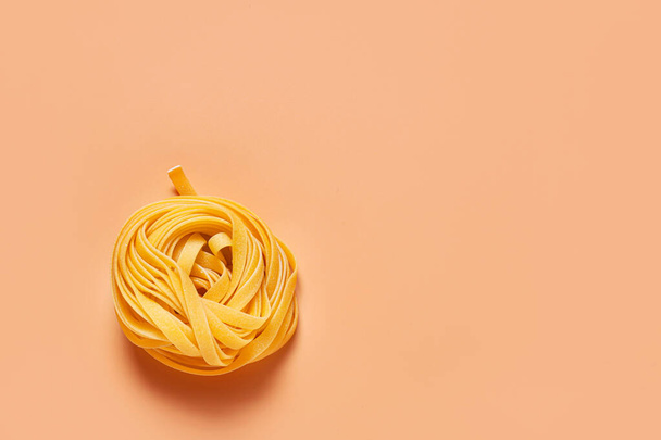 Dry pasta on color background - Fotó, kép
