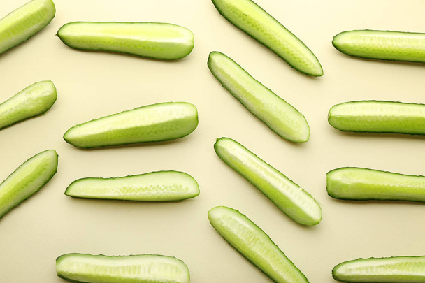 Pieces of fresh cucumbers on light background - Fotoğraf, Görsel
