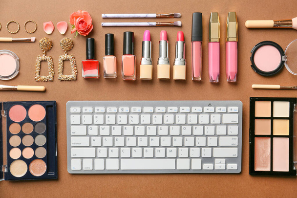 PC keyboard, set of decorative cosmetics and accessories on color background - Foto, afbeelding