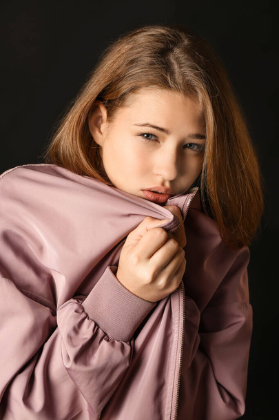 Sad teenage girl on dark background - Valokuva, kuva