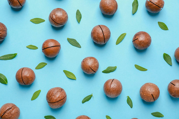 Tasty macadamia nuts on color background - Photo, Image