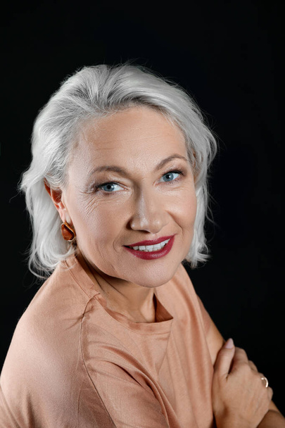 Portrait of stylish mature woman on dark background - Zdjęcie, obraz