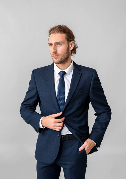 Portrait of businessman on grey background - Фото, зображення