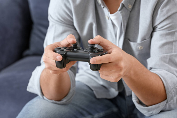 Teenager boy playing video games at home, closeup - Photo, Image