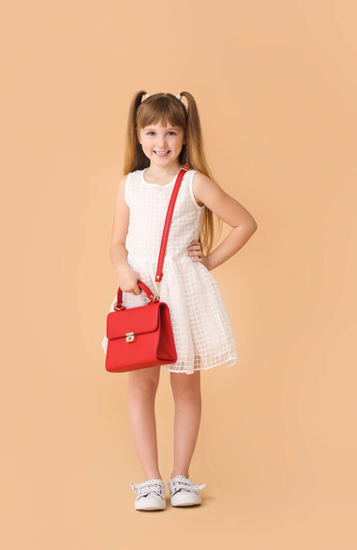 Fashionable little girl on color background - Фото, зображення