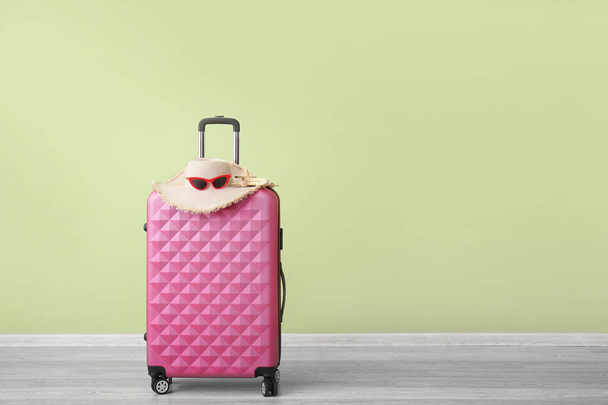 Packed suitcase near color wall. Travel concept - Φωτογραφία, εικόνα