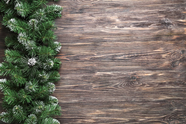 Beautiful fir branches on wooden background - Photo, Image