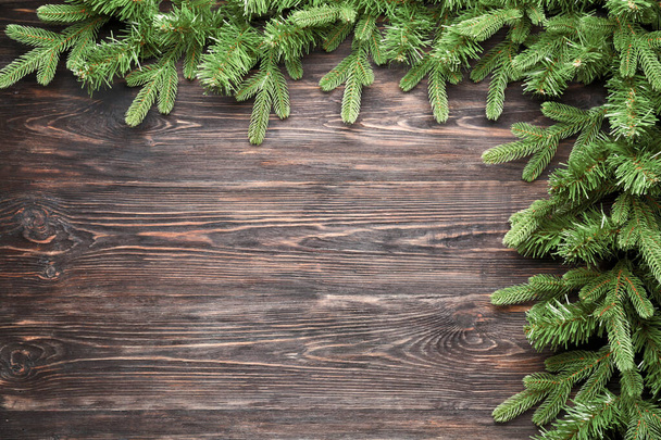 Beautiful fir branches on wooden background - 写真・画像