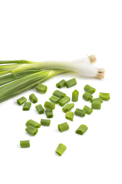 Fresh ripe green spring onions (shallots or scallions) with fresh chopped green onions on white background - Photo, image