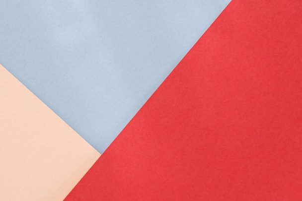 Red blue beige paper background. Geometric figures, shapes. Abstract geometric flat composition. Empty space on monochrome cardboard. - Photo, Image