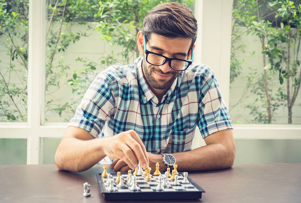 Casual businessman playing chess game with retro style photo, in - Фото, зображення