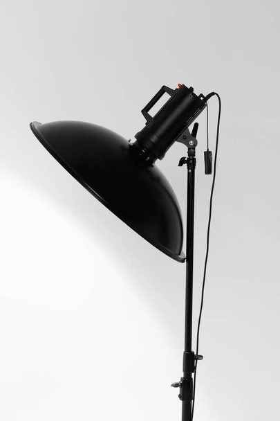 Beauty-Dish-Studioblitz auf einem Blitzgerät in einer Lichtwerkstatt montiert, Modellierlicht eingeschaltet - Foto, Bild