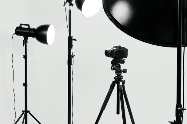 Camera with lighting equipment in studio  - Photo, Image