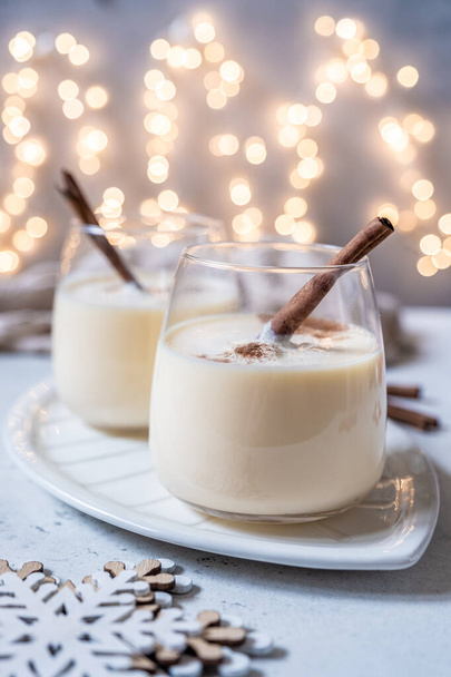 Traditional Christmas drink eggnog with cinnamon - 写真・画像