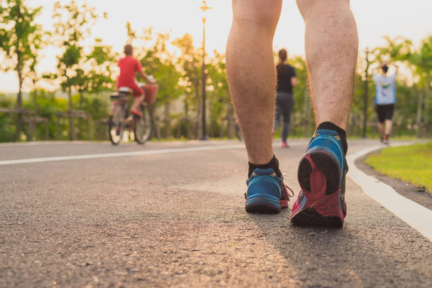Closeup shoe. Male legs jogging and walking on the running track - Zdjęcie, obraz